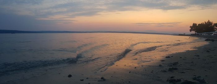 Scenic view of beach against sky during sunset