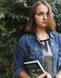 Portrait of beautiful woman with text on plant