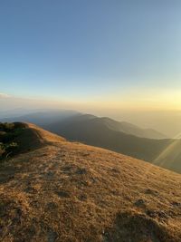 Scenic view of mountains against clear sky during sunset
