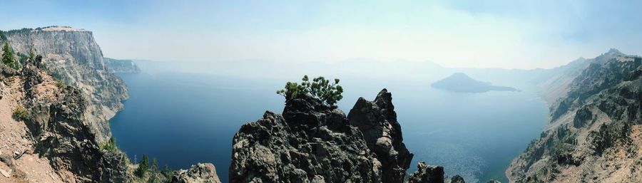 Panoramic view of rocks and sea against sky