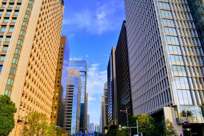 Low angle view of modern buildings in city against sky