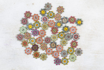 Colorful ornamental button on the white background, backdrop