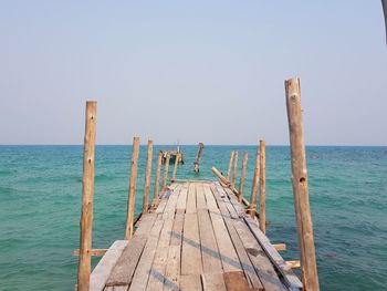 Pier over sea against clear sky