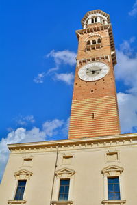 Low angle view of clock tower against blue sky