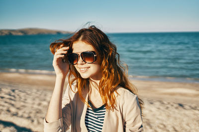 Portrait of smiling young woman on beach