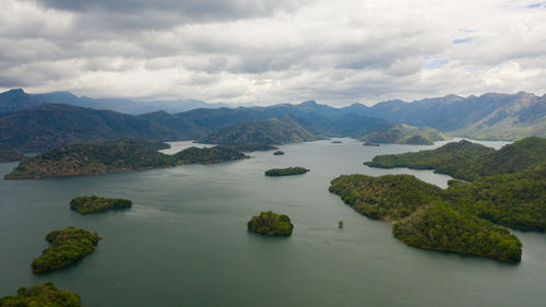 Scenic view of sea and mountains against sky