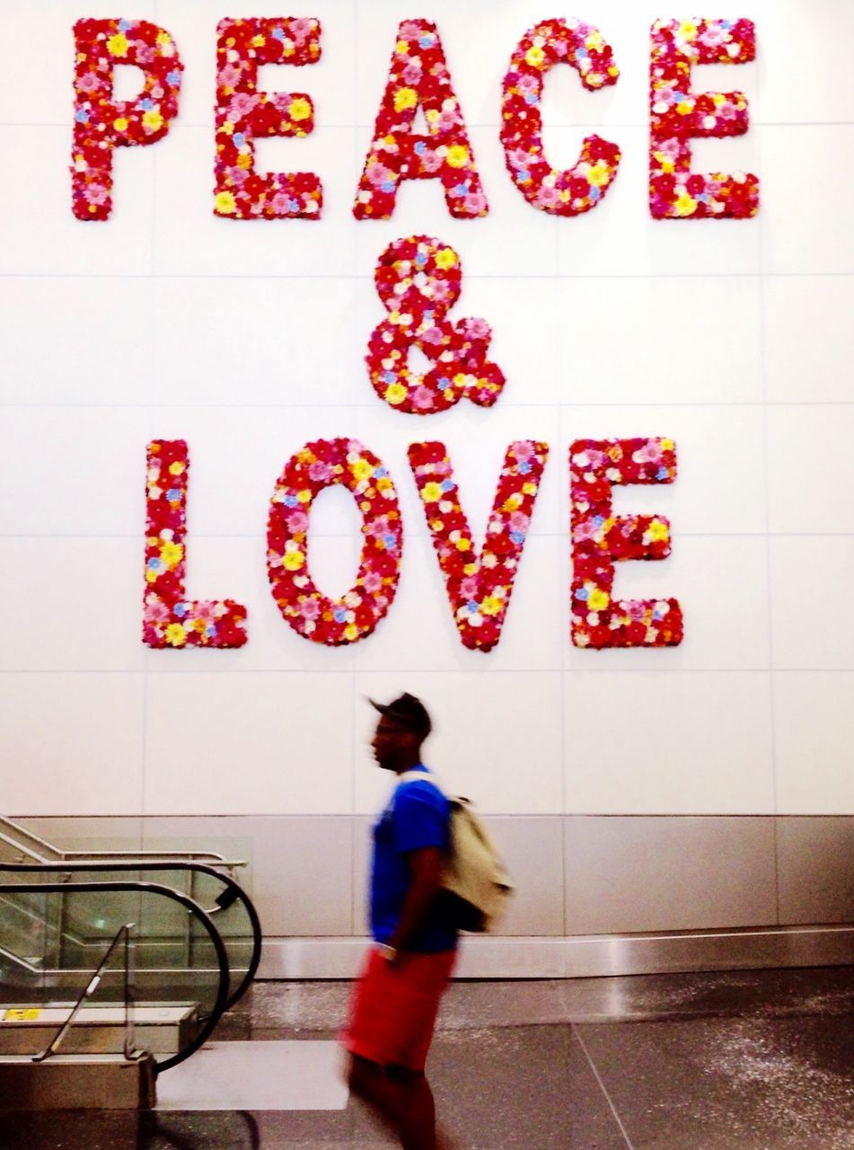 text, communication, western script, wall - building feature, indoors, red, non-western script, sign, capital letter, lifestyles, wall, number, tile, information, message, creativity, built structure, tiled floor