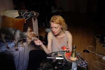 Young woman with dog at home