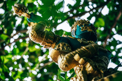 Low angle view of statue against trees