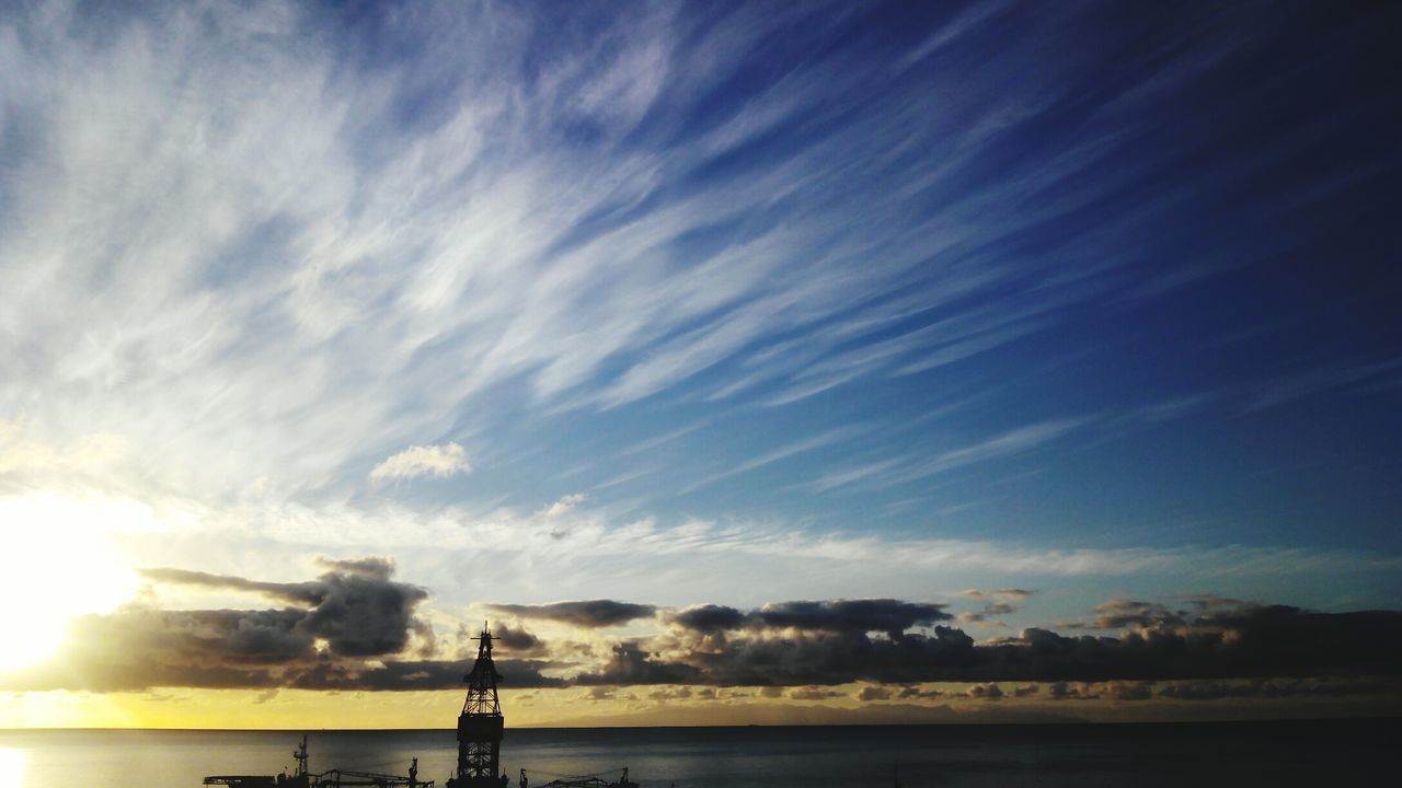 sky, silhouette, sunset, sun, beauty in nature, tranquility, scenics, cloud - sky, tranquil scene, nature, water, sea, sunlight, cloud, idyllic, sunbeam, outdoors, no people, horizon over water, cloudy