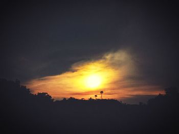 Scenic view of silhouette landscape against orange sky