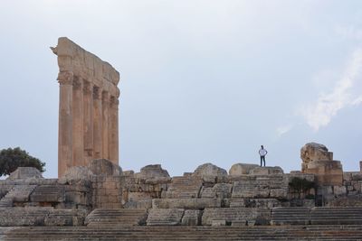 Distant view of man standing on old ruins