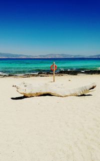 Scenic view of beach against clear blue sky