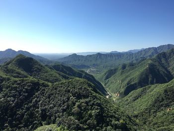 Scenic view of mountains against clear blue sky