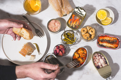 Cropped hands of person preparing food on table