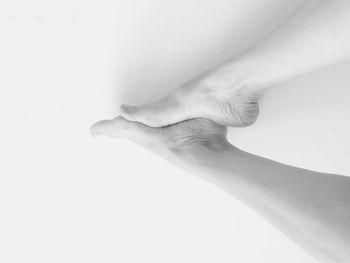 Low section of woman against white background