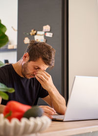 Young woman using laptop at home