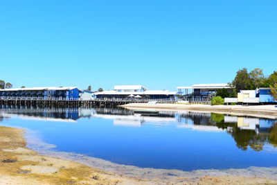 Built structures against clear blue sky