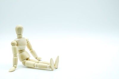 Close-up of wooden figurine against white background