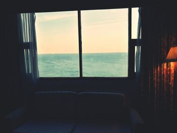 Scenic view of sea against sky seen through window