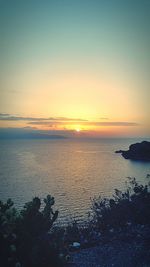 Scenic view of sea against romantic sky at sunset