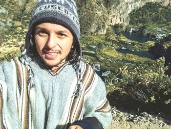 Portrait of smiling young woman sitting outdoors