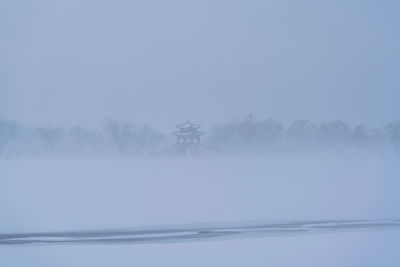 Scenic view of lake against clear sky during winter