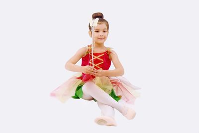 Portrait of girl wearing mask against white background