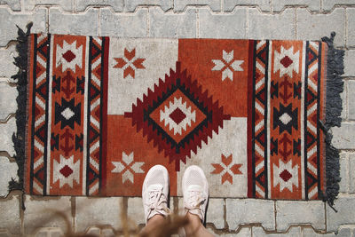 Woman tourist stands on a traditional turkish carpet