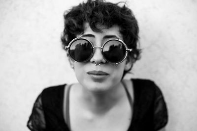 Close-up portrait of young woman wearing sunglasses