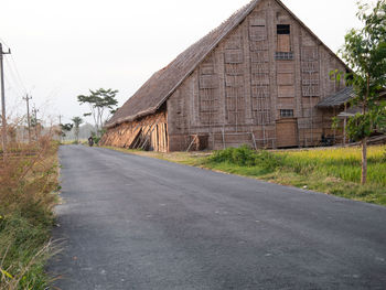 Road amidst buildings against sky