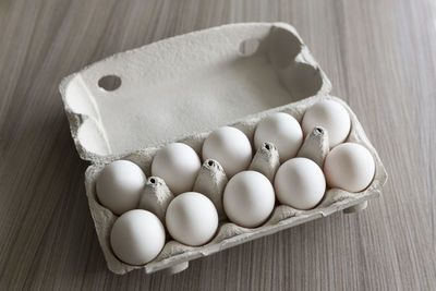 High angle view of eggs in crate on table