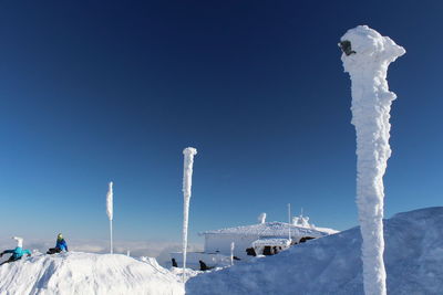 Panoramic view of snowcapped mountains against clear blue sky
