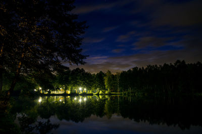 Scenic view of lake against sky at night