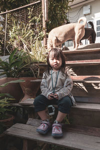 Portrait of girl sitting on staircase