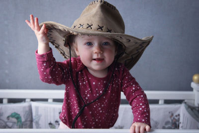 Portrait of cute girl smiling in cowboy hat