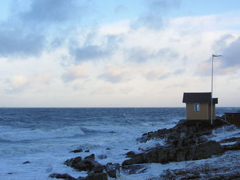 Scenic view of sea against cloudy sky