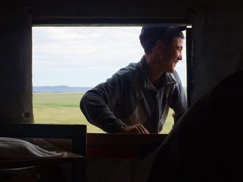 Woman looking through window