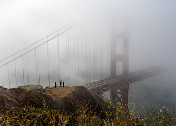 View of suspension bridge in foggy weather