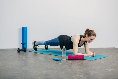 Woman looking away while sitting on floor