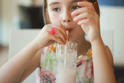 Close-up of girl drinking a milkshake