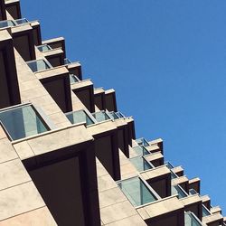 Low angle view of buildings against clear blue sky