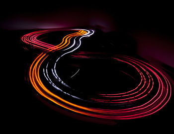 Close-up of light trails over black background