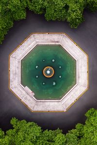 High angle view of arrow symbol on green wall