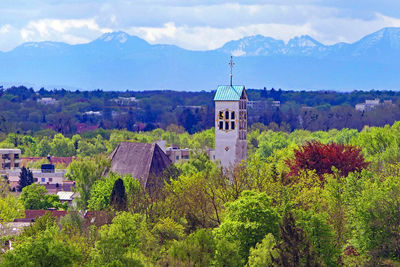 Panoramic view of trees and buildings against sky