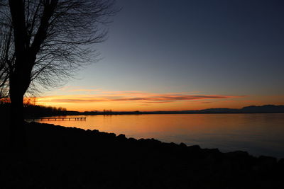 Scenic view of lake against sky during sunset