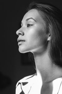 Close-up portrait of young woman looking away