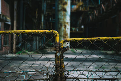 Close-up of chainlink fence against railing