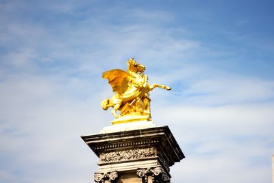 Low angle view of statue against cloudy sky