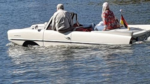 People sitting on boat in sea